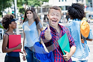 Successful brazilian male student with group of students