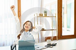 Successful business concept, Businesswoman raising arm to stretching after hard working new project