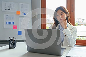 Successful business concept, Businesswoman thoughtful and read financial report on laptop in office