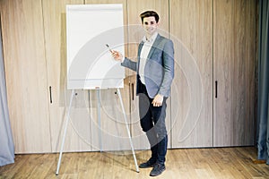 Successful business man with a flip chart in a presentation in modern office