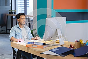 Successful business man with his staff in background at office