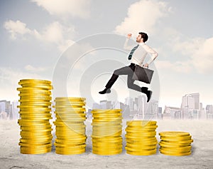 Successful business man jumping up on gold coin money