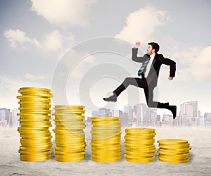 Successful business man jumping up on gold coin money