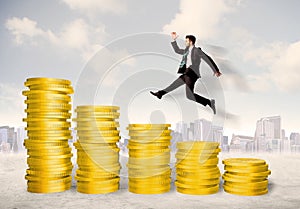 Successful business man jumping up on gold coin money