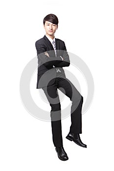 Successful business man sitting on something