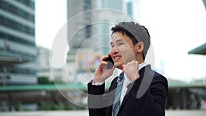 Successful business man talking a mobile phone in city