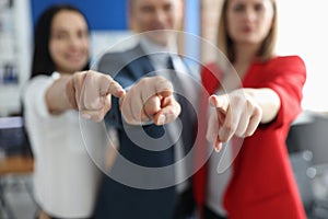 Successful business partners pointing finger in front of them closeup