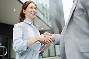 Successful business people handshaking closing a deal