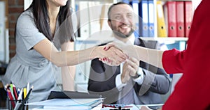 Successful business people shake hands when finishing meeting