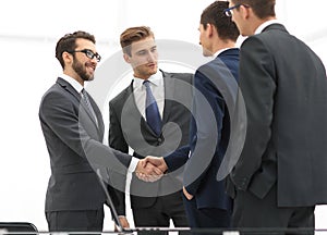 Successful business people shaking hands in an office.