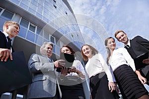 Successful business people team standing together outdoors near modern office building