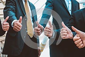 Successful business people with thumbs up and smiling, business