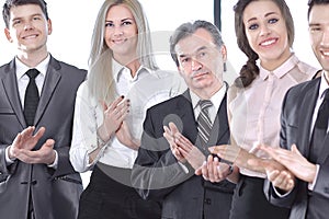 Successful business team applauding at the office
