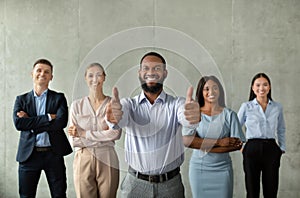 Successful Business Team. Black Male Ceo Posing With Smiliing Employees In Office