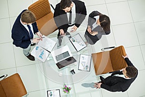 Successful business team discussing marketing graphics at a working meeting