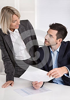 Successful business team: Female boss talking with her colleague