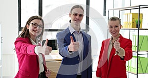 Successful business team gives thumbs up concept
