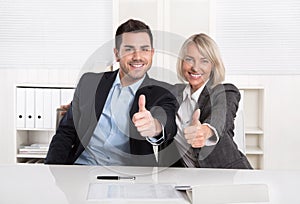 Successful business team or happy business people making recommendation gesture.