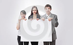 Successful business team holding a blank banner.