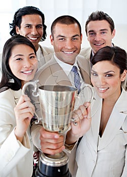 A successful business team holding a trophy