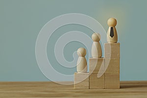 Successful business team leader concept: Businessman standing at the highest point on Wooden block. depicts of career growth up or