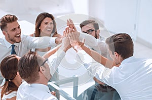 Successful business team is putting their palms together