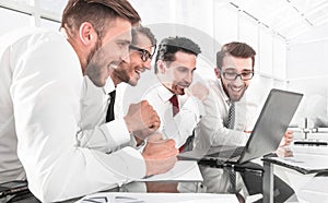 Successful business team using laptop for work