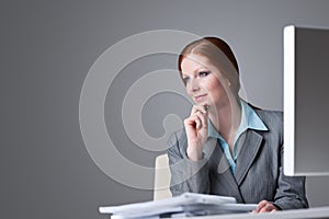 Successful business woman at office thinking