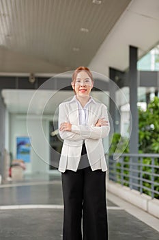 Successful business woman standing outside a office building