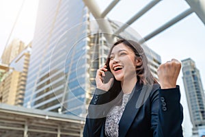 Successful business woman talking with mobile phone in city
