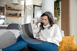 Successful business woman working at home in office work space on laptop computer planning wedding or event for client. Small