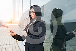 Successful business woman working with tablet in an urban setting