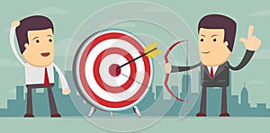 Successful businessman aiming target