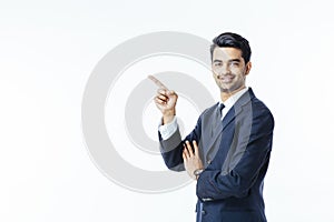 Successful businessman in black suit and tie pointing up