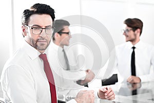 Successful businessman on blurred office background