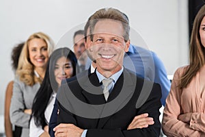 Successful Businessman Boss Over Businesspeople Group Background, Mature Leader With Business People Team Confident Hold
