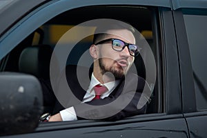 Successful businessman driving luxury car.