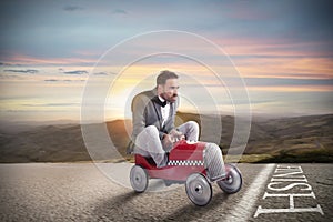 Successful businessman on the finishing line with his car