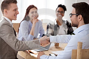 Successful businessman handshaking in office conference room