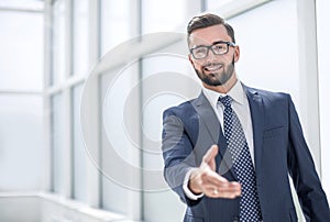 Successful businessman holding out his hand for a handshake