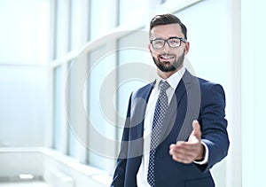 Successful businessman holding out his hand for a handshake