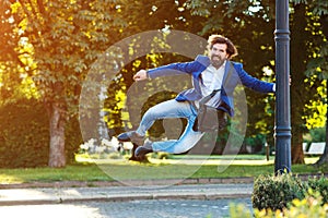 Successful businessman jumping at city street. Business Concept. Bearded man in formal suit outdoors
