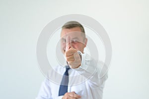 Successful businessman making a thumbs up gesture