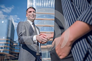 Successful businessman meeting a young employee with a handshake.