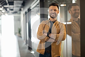 Successful Businessman Posing Standing In Doorway In Office