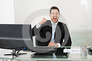 Successful businessman screaming at desk