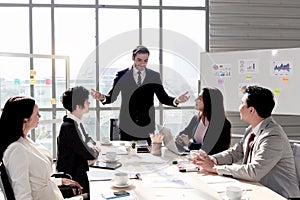 Successful businessman sharing experience success and giving presentation at conference meeting desk, five businesspeople having