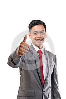 successful businessman showing thumbs up at camera isolated on white