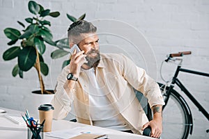 Successful businessman sitting in office and talking