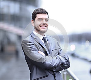 Successful businessman standing on the balcony of the office